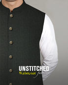 Admani premium unstitched menswear waistcoat fabric in a black diamond geometric pattern weave paired with metal buttons and white shalwar kameez.