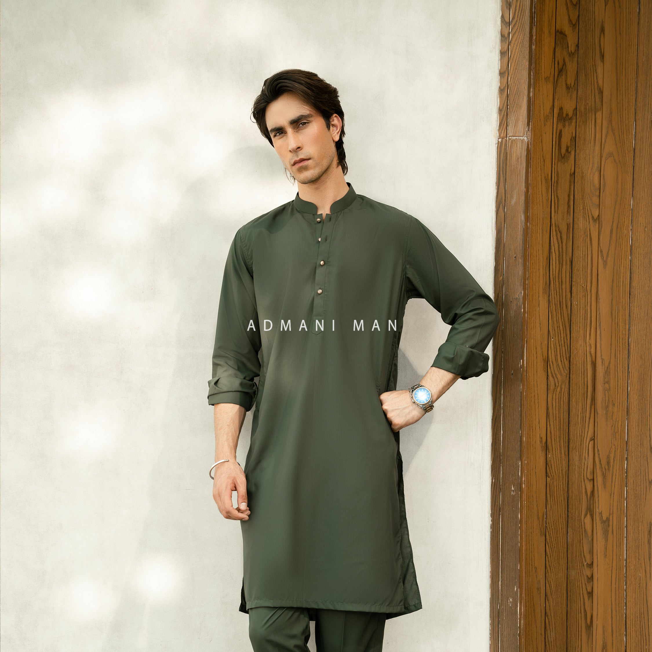Admani Man premium green kurta - Unstitched fabric for menswear shalwar kameez in Pakistan with traditional wooden door styling